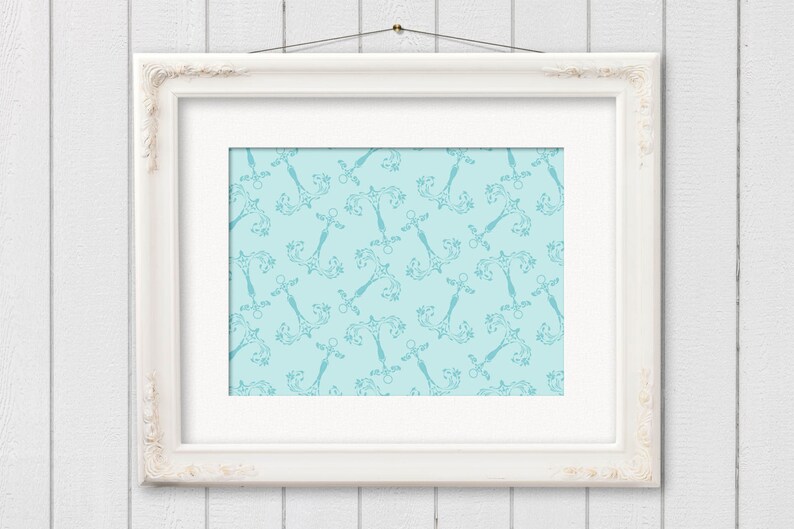 May include: A framed print featuring a repeating pattern of ornate, teal-colored decorative elements on a light blue background. The print is set within a white, ornate frame, hanging against a white wooden wall.