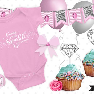 May include: Pink baby onesie with the text "leaving a little sparkle everywhere I go" and silver glitter diamond and heart cupcake toppers. The onesie is surrounded by silver glitter and pink diamond decorations.