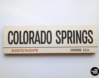 Colorado Springs Holiday Travel Sign: Distressed Wooden Destination Art