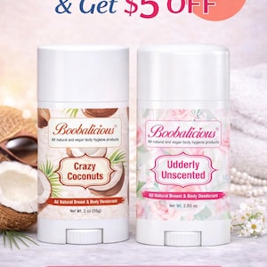 Op de afbeelding: Twee witte deodorantsticks van het merk "Boobalicious" worden getoond. Eén is "Crazy Coconuts" en de andere "Udderly Unscented". De "Crazy Coconuts" deodorant weegt 55g, en "Udderly Unscented" weegt 72g. De tekst "Buy Two & Get 5$ OFF" staat bovenaan.