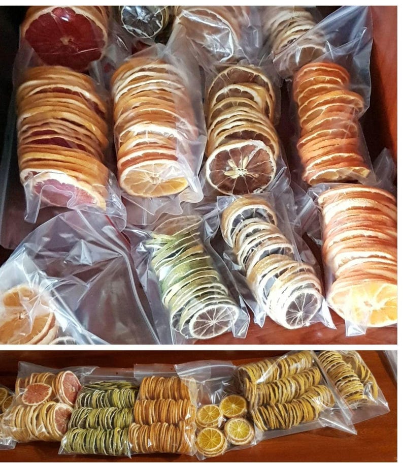 May include: Assortment of dried citrus fruit slices in various colours and sizes, packaged in clear plastic bags. The fruit slices are arranged in rows and columns, creating a visually appealing display.