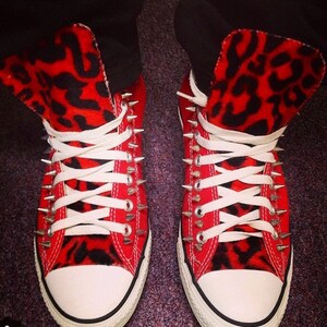 red spiked converse
