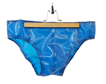 May include: Blue latex underwear hanging on a wooden hanger with the text "Ladylike latex" on the hanger.