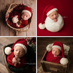 May include: A newborn baby wearing a red and white Santa hat with a white pom-pom, wrapped in a red blanket, and holding a gingerbread man. The baby is lying in a wooden box with a red blanket.