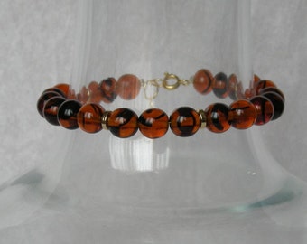 Round brown glass and gold beaded bracelet