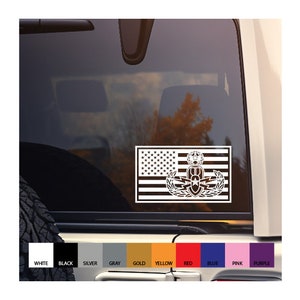 May include: A white vinyl decal of an American flag with an EOD (Explosive Ordnance Disposal) badge on top. The decal is on the back window of a car. The decal is available in a variety of colors.