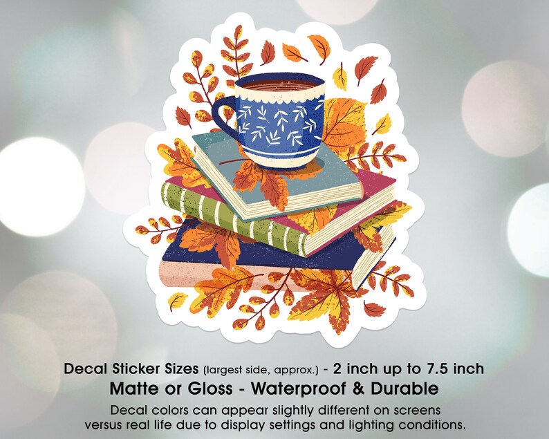 May include: A sticker featuring a blue coffee mug with a white pattern, sitting on top of a stack of books with autumn leaves. The sticker is available in matte or gloss finishes and is waterproof and durable. The sticker is 2 inches up to 7.5 inches in size.