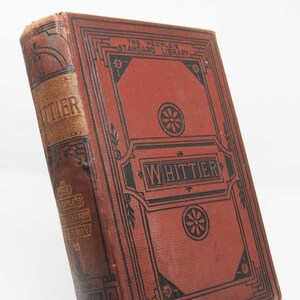 May include: A red book with black and gold accents. The title "Whittier" is printed in gold on the spine and in black on the front cover. The book is part of "The People's Standard Library".