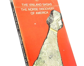 May include: A Penguin Classics paperback book titled The Vinland Sagas: The Norse Discovery of America. The cover is bright orange with a black spine and features a detailed, weathered metallic artifact illustration with intricate swirling patterns.