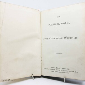 May include: A book titled "The Poetical Works of John Greenleaf Whittier" published by Ward, Lock, and Co. in London and New York.