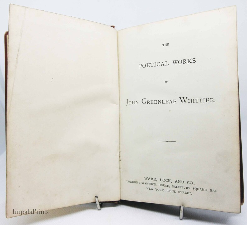 May include: A book titled "The Poetical Works of John Greenleaf Whittier" published by Ward, Lock, and Co. in London and New York.