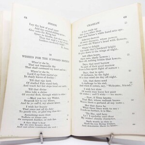 May include: An open book with poetry on display. The left page shows the poem "Jonson" and the right page shows the poem "Crashaw". A metal clip holds the book open.