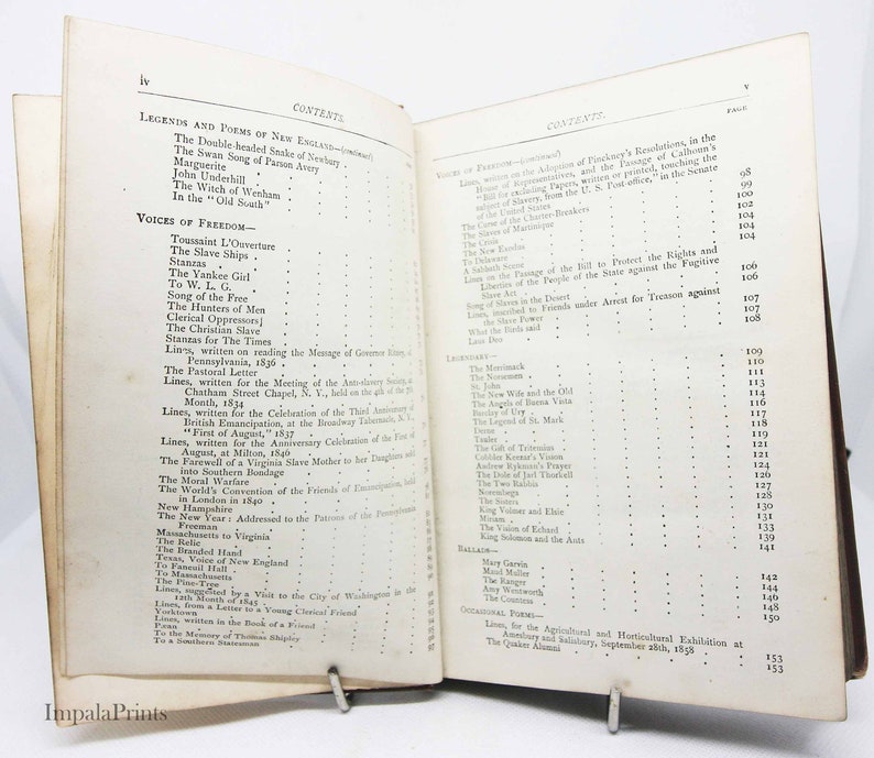 May include: An open book with a table of contents listing poems and legends of New England. The book is bound in brown leather with gold lettering on the spine. The pages are yellowed with age.