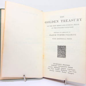 May include: An open book titled "The Golden Treasury" with text in English. The book's pages are cream-coloured, and the cover is green. The title is in large, bold letters, and the text includes the author's name and publisher information.