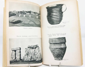 May include: Black and white photograph of Stonehenge, a prehistoric monument in England. The image shows some of the large standing stones that make up the monument.