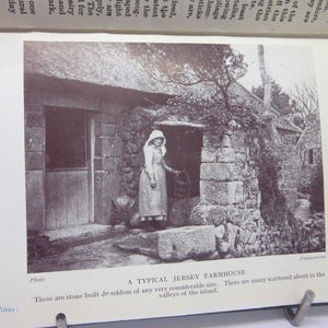 May include: A black and white photograph of a stone farmhouse with a thatched roof. A person in a long dress and bonnet stands in the doorway. The text reads "A TYPICAL JERSEY FARMHOUSE".