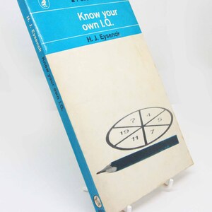 May include: Vintage paperback book titled "Know your own I.Q." by H.J. Eysenck. The book has a light blue and white cover with a graphic of a circle divided into sections with numbers and a pencil. The book is a Pelican Book.