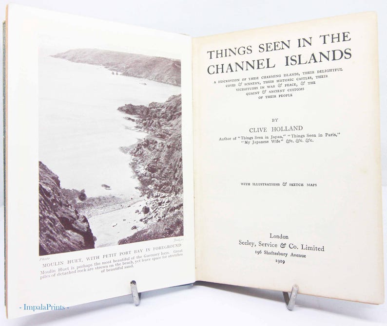 May include: Open book titled "Things Seen in the Channel Islands" by Clive Holland, published in 1929. The book features a black and white photograph of a coastal landscape and text describing the islands.