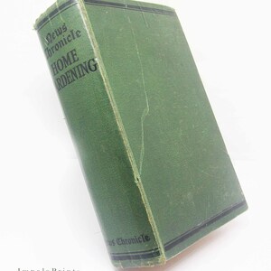May include: A vintage green hardcover book titled "News Chronicle Home Gardening." The book has black text and a black border on the cover. The book is slightly worn, suggesting age and use.