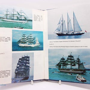 May include: A book page featuring images of sailing ships. The images include the USCGC Eagle, the British Topsail Schooner Sir Winston Churchill, the Italian ship Amerigo Vespucci, and the Russian Barque Kruzenshtern. The book is open, with a blue cover.