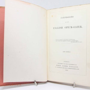 May include: A vintage book titled "Confessions of an English Opium-Eater" with a new edition published in 1851 by John James Tallant in London.