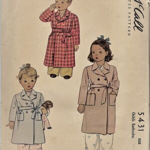 May include: Vintage McCall's sewing pattern for a child's bathrobe. The pattern is for size 6 and includes three different styles of bathrobes. The bathrobes are shown in red and white plaid, light blue, and beige.