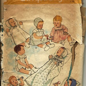 May include: A vintage Simplicity sewing pattern for baby clothes. The pattern is for five different outfits, including a christening gown, a dress, a romper, a coat, and a bonnet. The pattern is printed on a yellow background with the Simplicity logo and the price of $1.00.