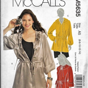 May include: Sewing pattern McCall's M5635 size A5 (6-8-10-12-14) for a hooded jacket and a blouse. The pattern includes instructions for sewing both garments.