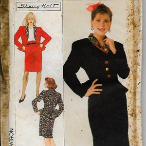 May include: Simplicity sewing pattern number 9314 for a skirt suit. The pattern includes two different styles, one with a red skirt and jacket and the other with a black skirt and jacket. The pattern is for sizes 38, 40, and 42.