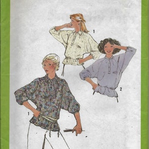 May include: Simplicity sewing pattern number 8885 for a blouse with a gathered waist. The pattern includes three different styles: a floral print blouse, a white blouse, and a lavender blouse. The pattern is for size 8 miss.