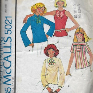 May include: A sewing pattern for four different tops with embroidery designs. The pattern is for misses' sizes and includes a blue transfer for embroidery.