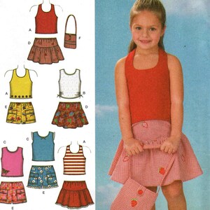 May include: Simplicity sewing pattern number 4611 for girls' dresses and skirts. The pattern includes a red and white gingham skirt, a red tank top, a yellow tank top, a white tank top, a blue tank top, a red and white striped tank top, a pair of yellow shorts, a pair of blue denim shorts, and a red skirt. The pattern is for sizes AA 3, 4, 5, and 6.
