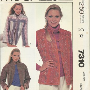 May include: A sewing pattern for a vest and jacket. The pattern is from McCall's and is for a miss size small. The pattern number is 7310. The vest is red with a floral design and the jacket is brown.