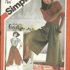 May include: A Simplicity sewing pattern for culottes, size 10, waist 25 inches. The pattern features a woman wearing a red sweater and green culottes. The pattern is for Ricki for finity.
