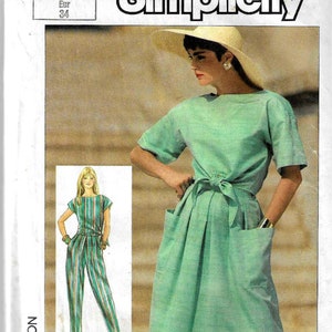 May include: Simplicity sewing pattern number 7319 for a dress and jumpsuit. The dress is green with a tie belt and pockets. The jumpsuit is striped in green, white, and brown. The pattern is for sizes 6-34.