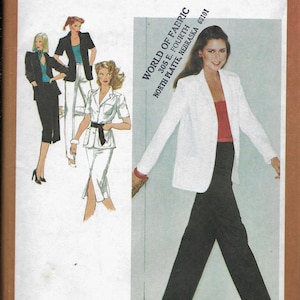 May include: A white blazer with long sleeves and a single button closure. The blazer is paired with black pants. The image includes the text "Simplicity 9314" and "World of Fabric 305 E. Fourth North Platte, Nebraska 69101".