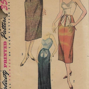 May include: A vintage sewing pattern for a skirt with three different styles. The pattern is printed on a beige paper with a pink and white border. The pattern number is 4004. The waist measurement is 24 inches and the hip measurement is 33 inches.