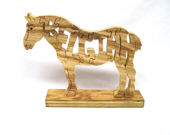 May include: Wooden horse puzzle with the name "REAGAN" spelled out in the horse's body. The puzzle is on a wooden base.