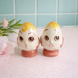 May include: A set of three ceramic mugs with a speckled, matte finish. The mugs are in shades of cream, light gray, and dark gray. Each mug has a simple, minimalist design, perfect for coffee or tea.