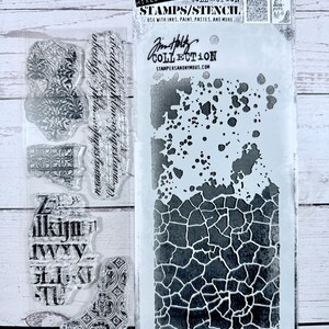 May include: A mixed-media stamps and stencil set by Stampers Anonymous. The set includes clear stamps with ornate designs and a stencil with a cracked pattern. The packaging features the text "STAMPS/STENCIL" and "Tim Holtz Collection".
