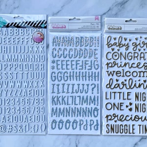 Thickers- Dear Lizzy Bonjour Glitter,Ciottoli NIGHT NIGHT GOLDIE Schiuma per bambina in lamina d'oro, Adesivi con alfabeto in truciolato bianco Heidi Swapp