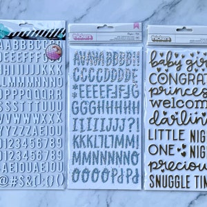 Thickers- Dear Lizzy Bonjour Glitter,Pebbles NIGHT NIGHT GOLDIE Gold Foil Baby Girl Foam, Heidi Swapp White Chipboard Alphabet Stickers