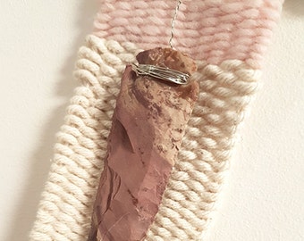 Pink wool and cotton weaving with agate arrowhead