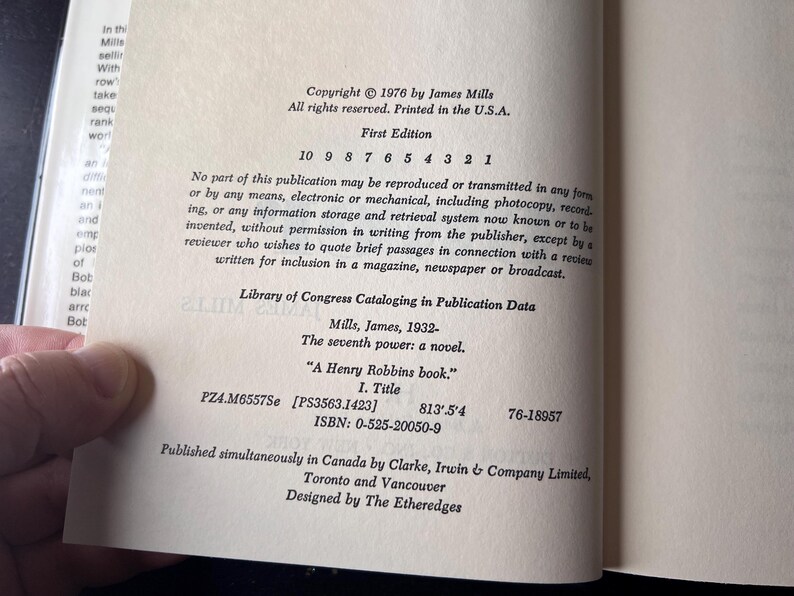 May include: Open book page with text. Copyright 1976 by James Mills. First Edition. Title: "A Henry Robbins book." ISBN: 0-525-20050-9. Library of Congress Cataloging in Publication Data. Published in Canada by Clarke, Irwin & Company Limited.
