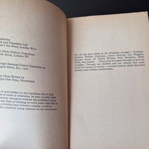 May include: A book titled "Free Angela Davis" with a copyright notice and publishing information. The book is about the liberation struggle and includes the names of those who have fallen in the struggle.