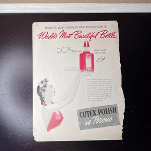 May include: Vintage advert for Cutex nail polish. The ad shows a woman holding a bottle of Cutex nail polish. The text reads "World's Most Beautiful Bottle" and "Cutex Polish is Porous."