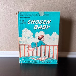 May include: A vintage book cover with a turquoise background and a white title that reads "The Chosen Baby". The book is about adoption and features an illustration of a child in a blue onesie looking over a railing.