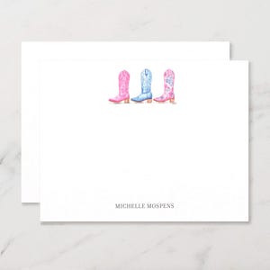 May include: Stationery set featuring three watercolor cowboy boots in pink, blue, and pink with blue floral accents. The boots are arranged on a white background with the name "MICHELLE MOSPENS" printed at the bottom.