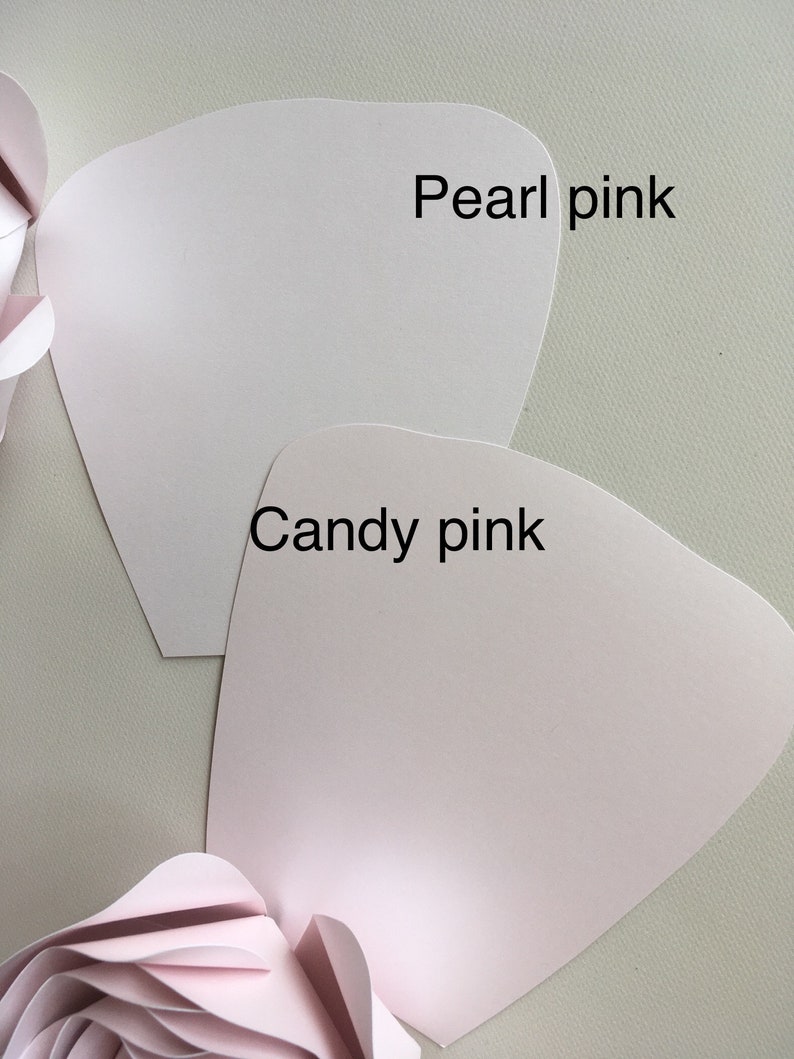 May include: Two pieces of paper in different shades of pink. The top piece is labeled "Pearl pink" and the bottom piece is labeled "Candy pink".