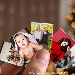 May include: A set of four photo cards featuring different people. The first card shows a baby in a white and purple blanket. The second card shows two women standing in a field of sunflowers. The third card shows a woman with long dark hair wearing a red top. The fourth card shows a woman with long blonde hair wearing a blue shirt and jeans.